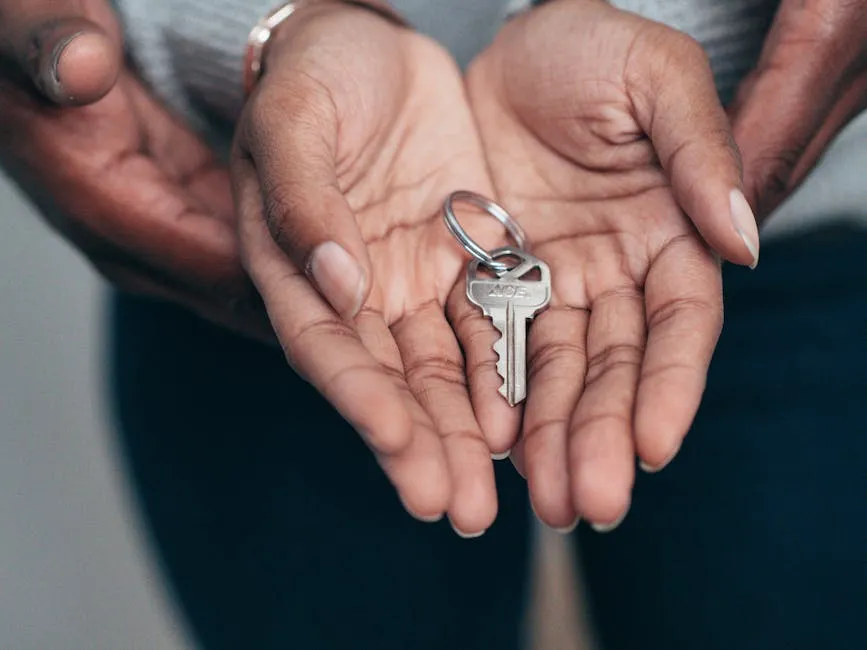 Close-up of hands holding a key, symbolizing homeownership, real estate, and property investment.