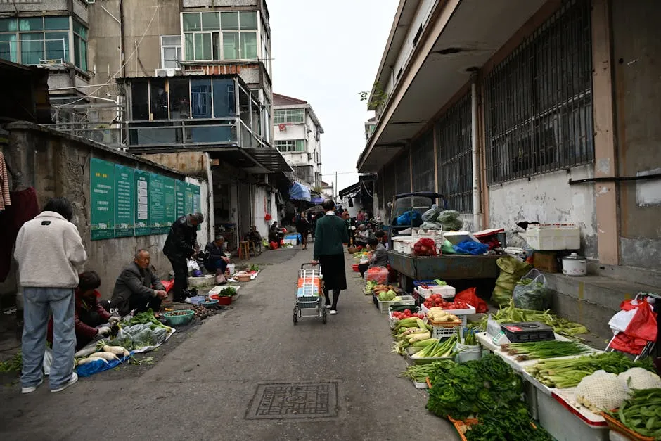 Busy street market showcasing a variety of fresh vegetables and vendors, creating a vibrant urban scene.