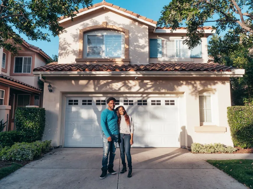 A joyous couple stands together in front of their newly purchased house, symbolizing new beginnings.