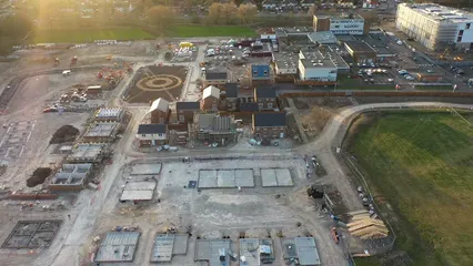 Horizontal video: An aerial view of a construction site with a large building in the foreground 18018696. Duration: 28 seconds. Resolution: 3840x2160