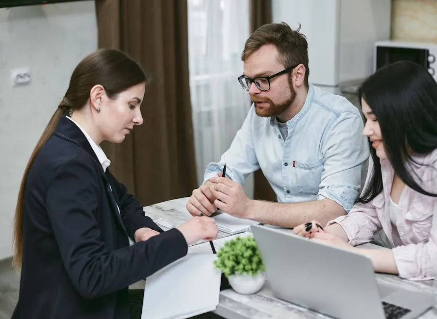 A couple discusses financial documents with their advisor, highlighting investment strategies.