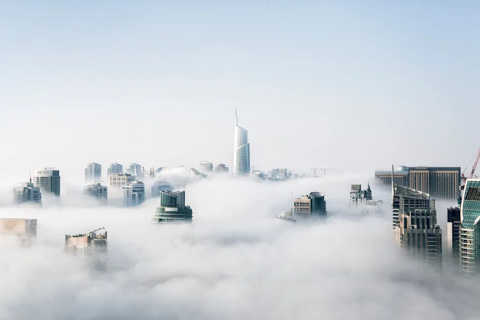 A stunning view of Dubai skyscrapers emerging through a blanket of fog, showcasing modern architecture.