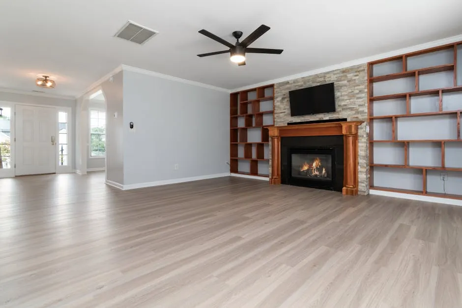 Bright, spacious living room with a modern fireplace and built-in shelves, perfect for home interiors.