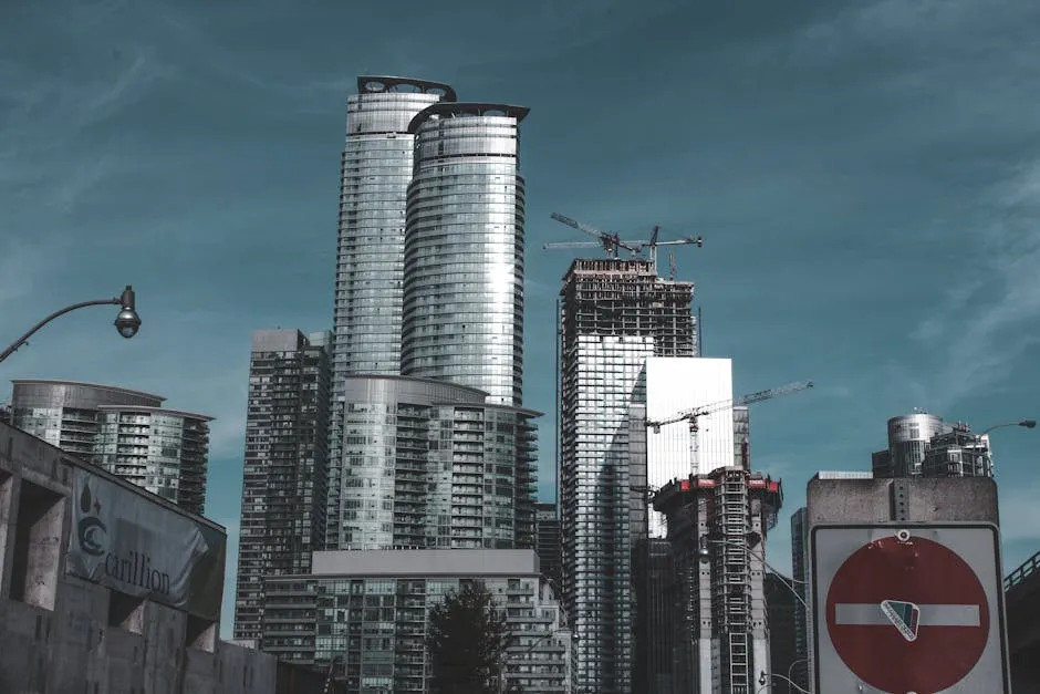 Cityscape of modern skyscrapers under construction with cranes during dusk, showcasing urban development.