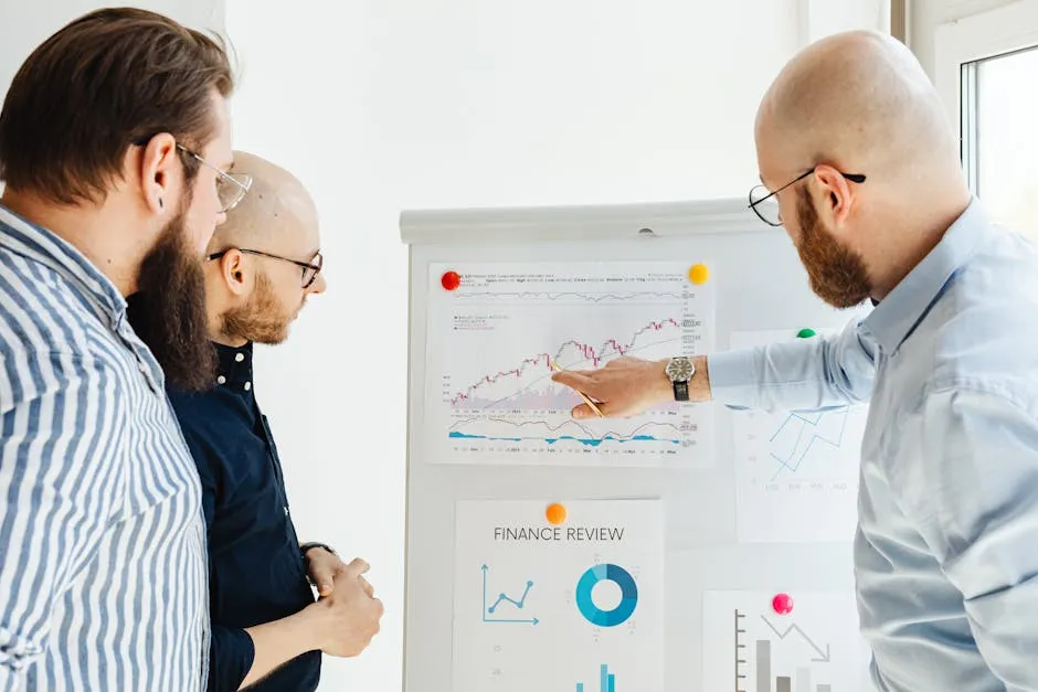 Business team reviewing financial charts during a strategy meeting indoors.