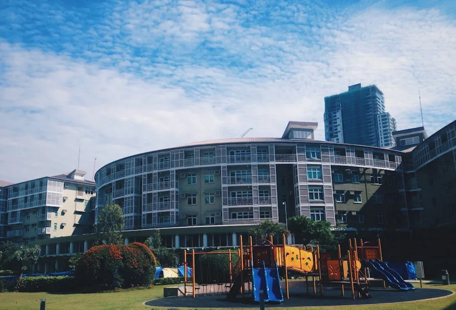 Contemporary apartment building with adjacent playground in urban setting.