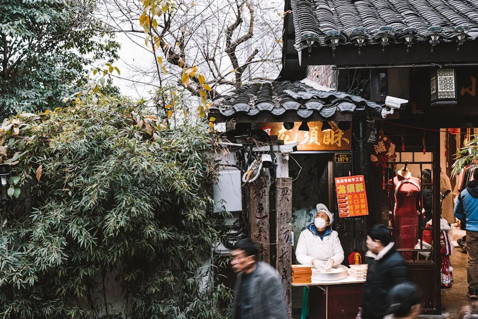 Bustling street scene with vendor and traditional clothing shop, capturing lively marketplace atmosphere.